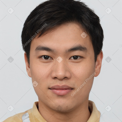 Joyful asian young-adult male with short  brown hair and brown eyes