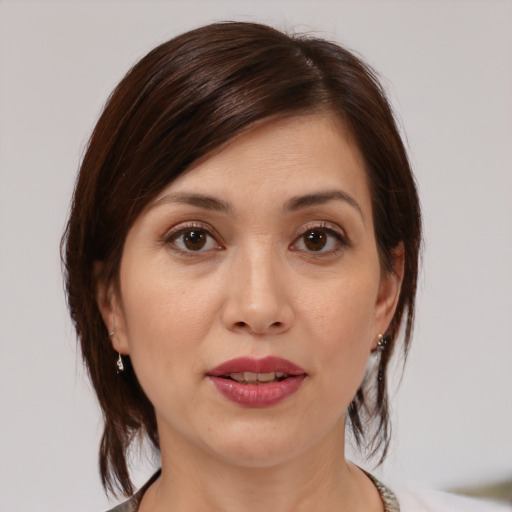 Joyful white young-adult female with medium  brown hair and brown eyes