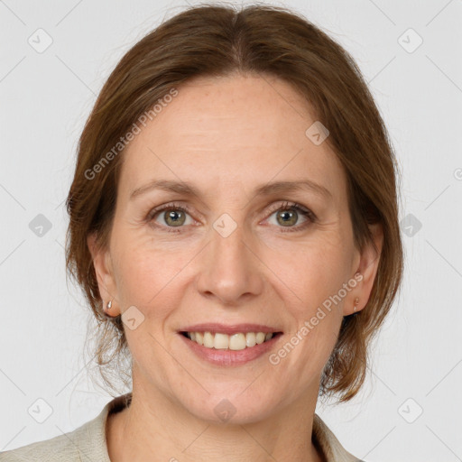 Joyful white adult female with medium  brown hair and grey eyes