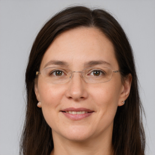 Joyful white adult female with long  brown hair and grey eyes