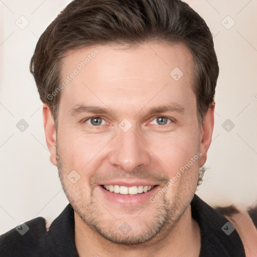 Joyful white adult male with short  brown hair and grey eyes