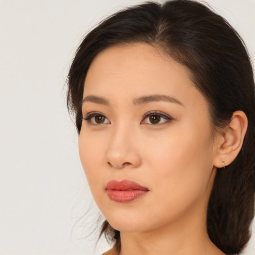 Joyful asian young-adult female with medium  brown hair and brown eyes