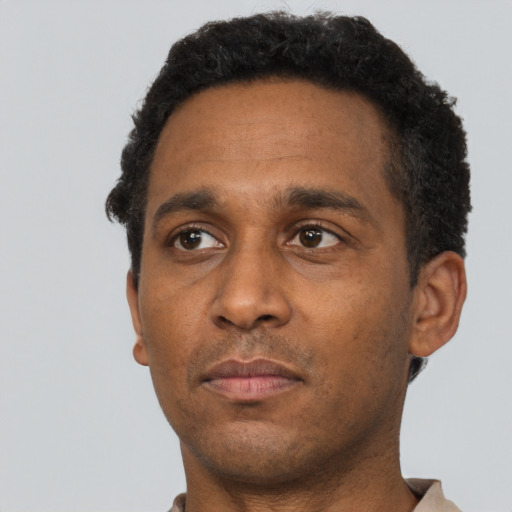 Neutral black adult male with short  brown hair and brown eyes