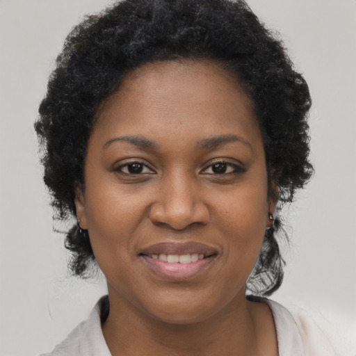 Joyful black young-adult female with short  brown hair and brown eyes
