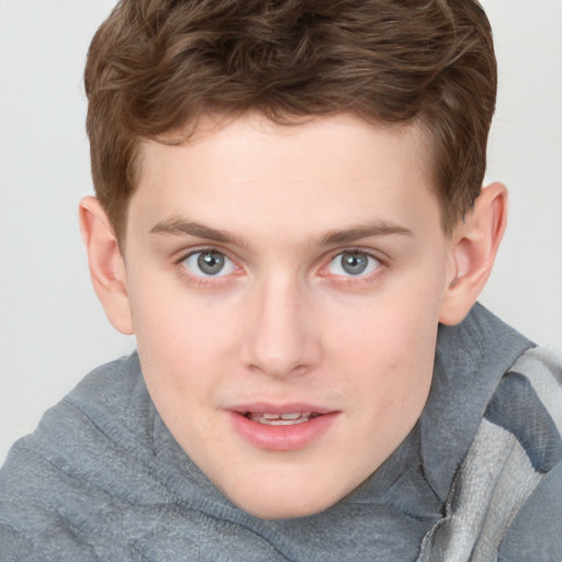 Joyful white young-adult male with short  brown hair and blue eyes