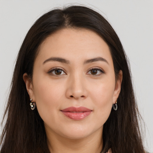 Joyful white young-adult female with long  brown hair and brown eyes