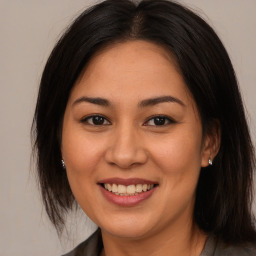 Joyful asian young-adult female with long  brown hair and brown eyes