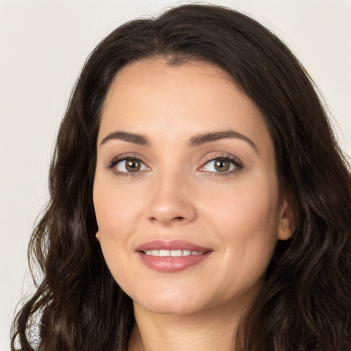 Joyful white young-adult female with long  brown hair and brown eyes