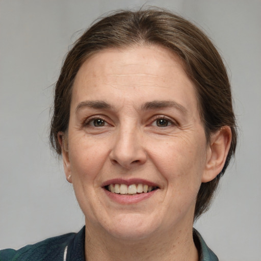 Joyful white adult female with medium  brown hair and brown eyes