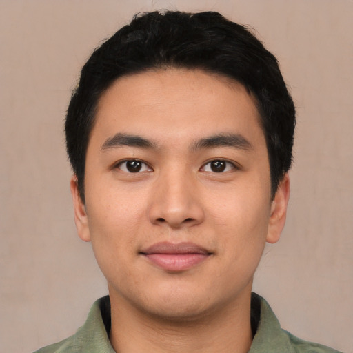 Joyful asian young-adult male with short  black hair and brown eyes