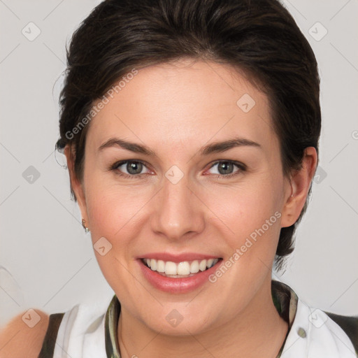 Joyful white young-adult female with medium  brown hair and green eyes