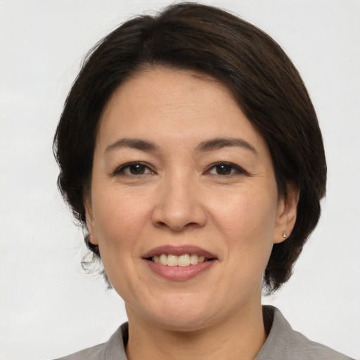 Joyful white adult female with medium  brown hair and brown eyes