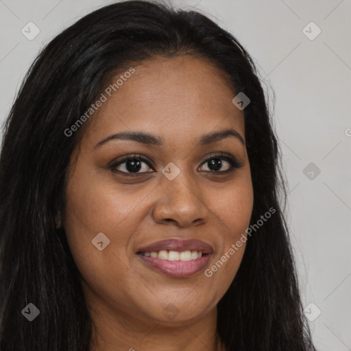 Joyful black young-adult female with long  brown hair and brown eyes