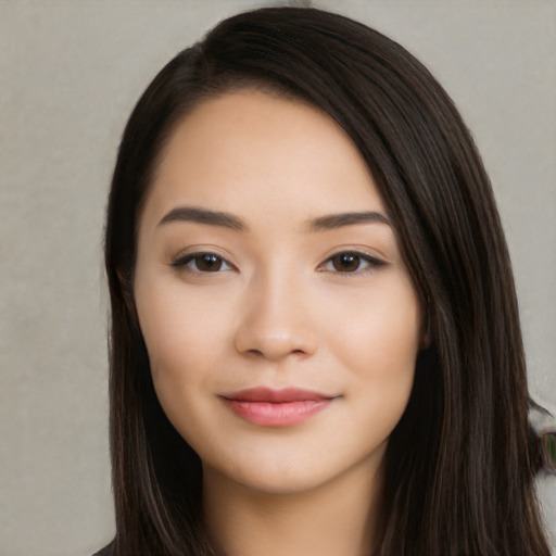 Joyful white young-adult female with long  black hair and brown eyes