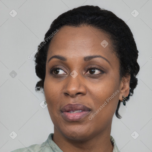 Joyful black adult female with short  black hair and brown eyes