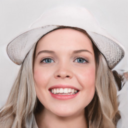 Joyful white young-adult female with long  brown hair and blue eyes