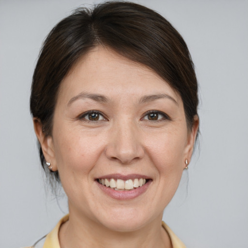Joyful white adult female with medium  brown hair and brown eyes