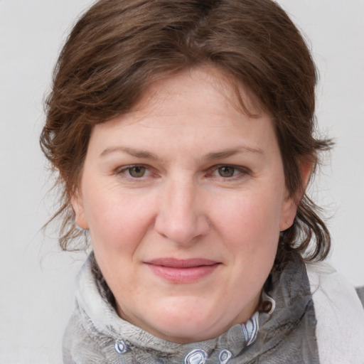 Joyful white young-adult female with medium  brown hair and blue eyes