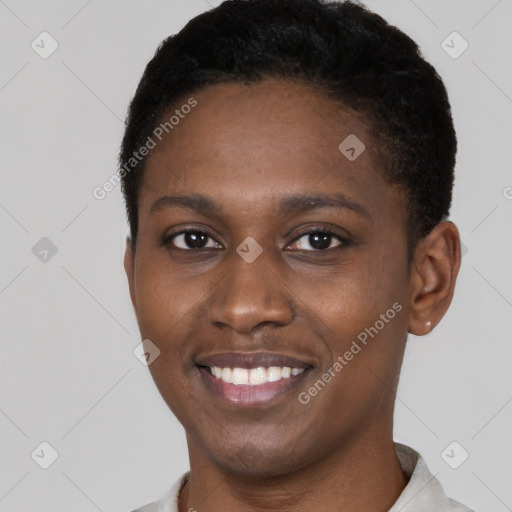 Joyful black young-adult female with short  black hair and brown eyes