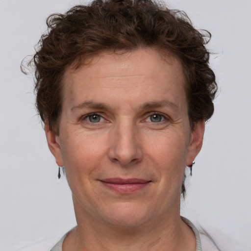 Joyful white adult female with short  brown hair and grey eyes