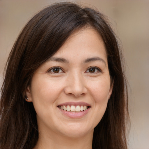 Joyful white young-adult female with long  brown hair and brown eyes