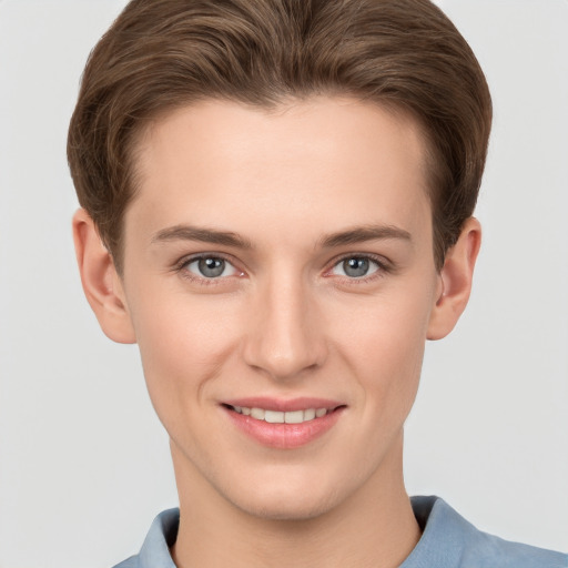 Joyful white young-adult female with short  brown hair and grey eyes