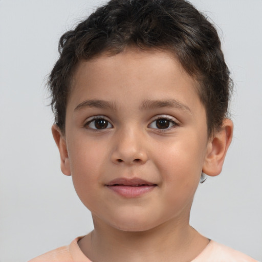 Joyful white child male with short  brown hair and brown eyes