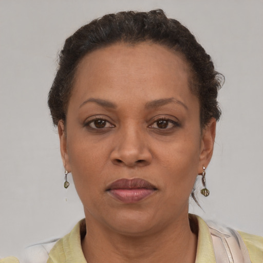 Joyful latino adult female with short  brown hair and brown eyes