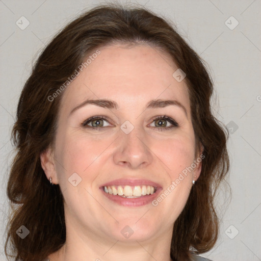 Joyful white adult female with medium  brown hair and green eyes