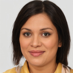 Joyful latino young-adult female with medium  brown hair and brown eyes