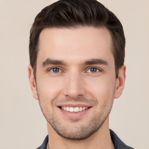 Joyful white young-adult male with short  brown hair and brown eyes