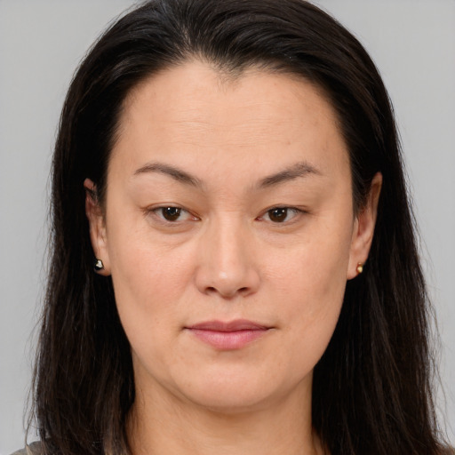 Joyful asian young-adult female with long  brown hair and brown eyes