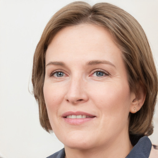 Joyful white adult female with medium  brown hair and grey eyes