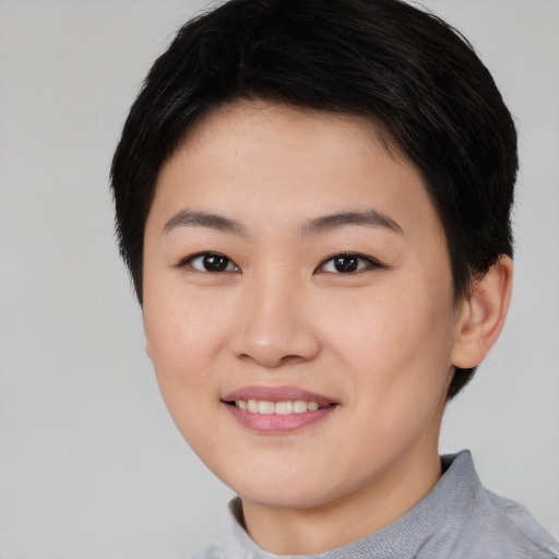 Joyful asian young-adult female with short  brown hair and brown eyes