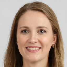 Joyful white young-adult female with long  brown hair and green eyes