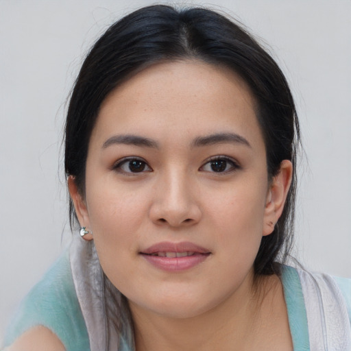 Joyful asian young-adult female with medium  black hair and brown eyes