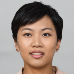 Joyful asian young-adult female with short  black hair and brown eyes