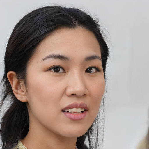 Joyful asian young-adult female with medium  brown hair and brown eyes