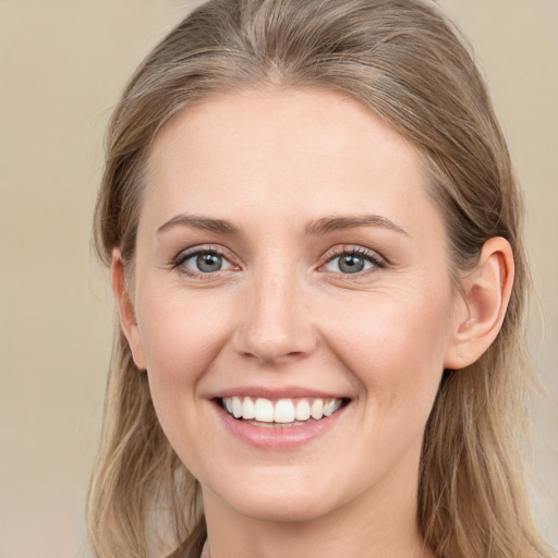 Joyful white young-adult female with long  brown hair and grey eyes