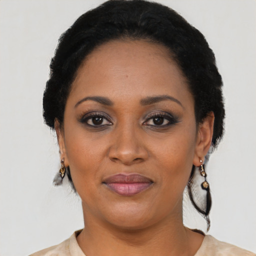 Joyful black adult female with short  black hair and brown eyes