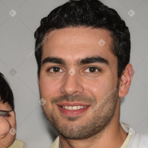 Joyful white young-adult male with short  black hair and brown eyes