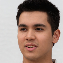 Joyful asian young-adult male with short  black hair and brown eyes