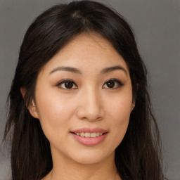 Joyful asian young-adult female with long  brown hair and brown eyes