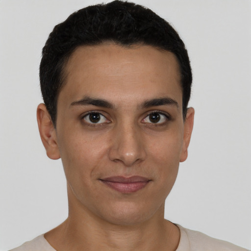 Joyful latino young-adult male with short  brown hair and brown eyes