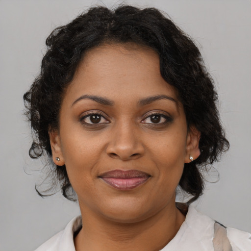 Joyful black young-adult female with medium  brown hair and brown eyes