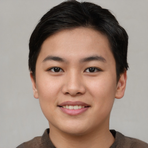 Joyful asian young-adult female with short  brown hair and brown eyes
