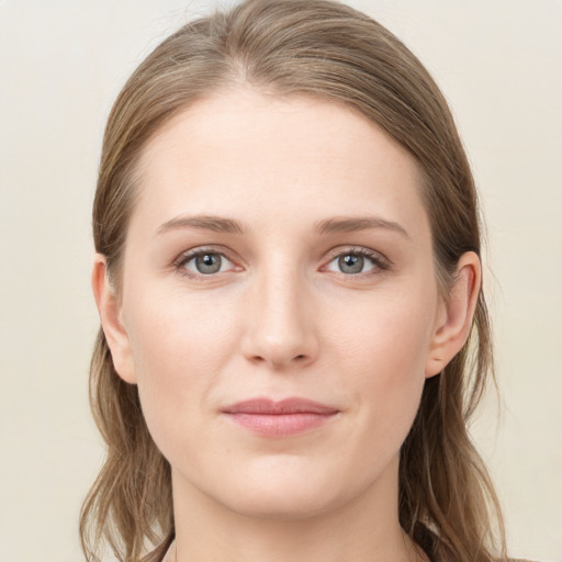 Joyful white young-adult female with long  brown hair and blue eyes