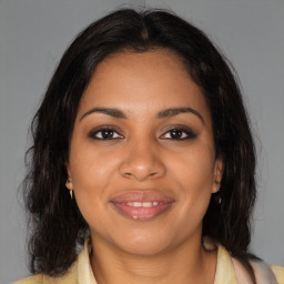 Joyful black young-adult female with medium  brown hair and brown eyes