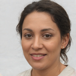 Joyful white adult female with medium  brown hair and brown eyes