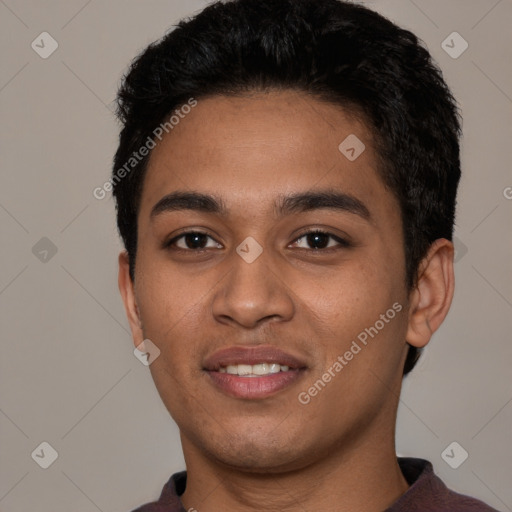 Joyful latino young-adult male with short  black hair and brown eyes